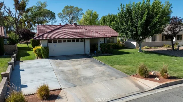 an aerial view of residential houses with outdoor space and street view