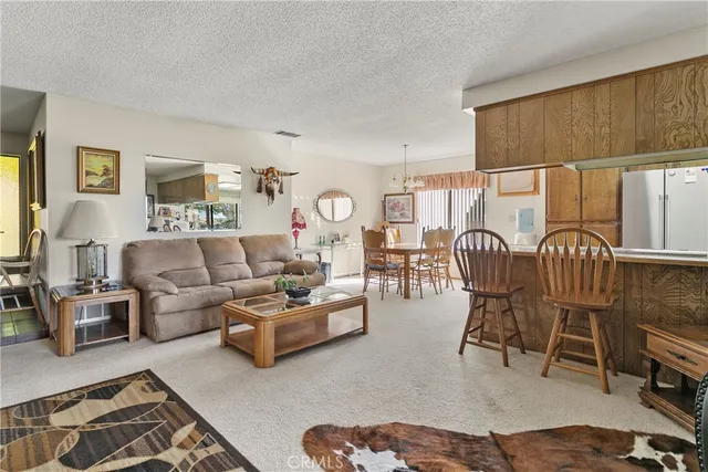 a view of a dining room with furniture and chandelier