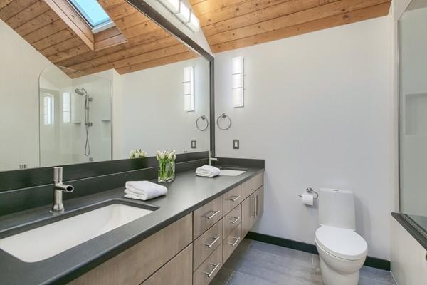 75 Mill Road Chelmsford, MA 01824 - Photo 14 of 17 a bathroom with a granite countertop sink a toilet and a mirror