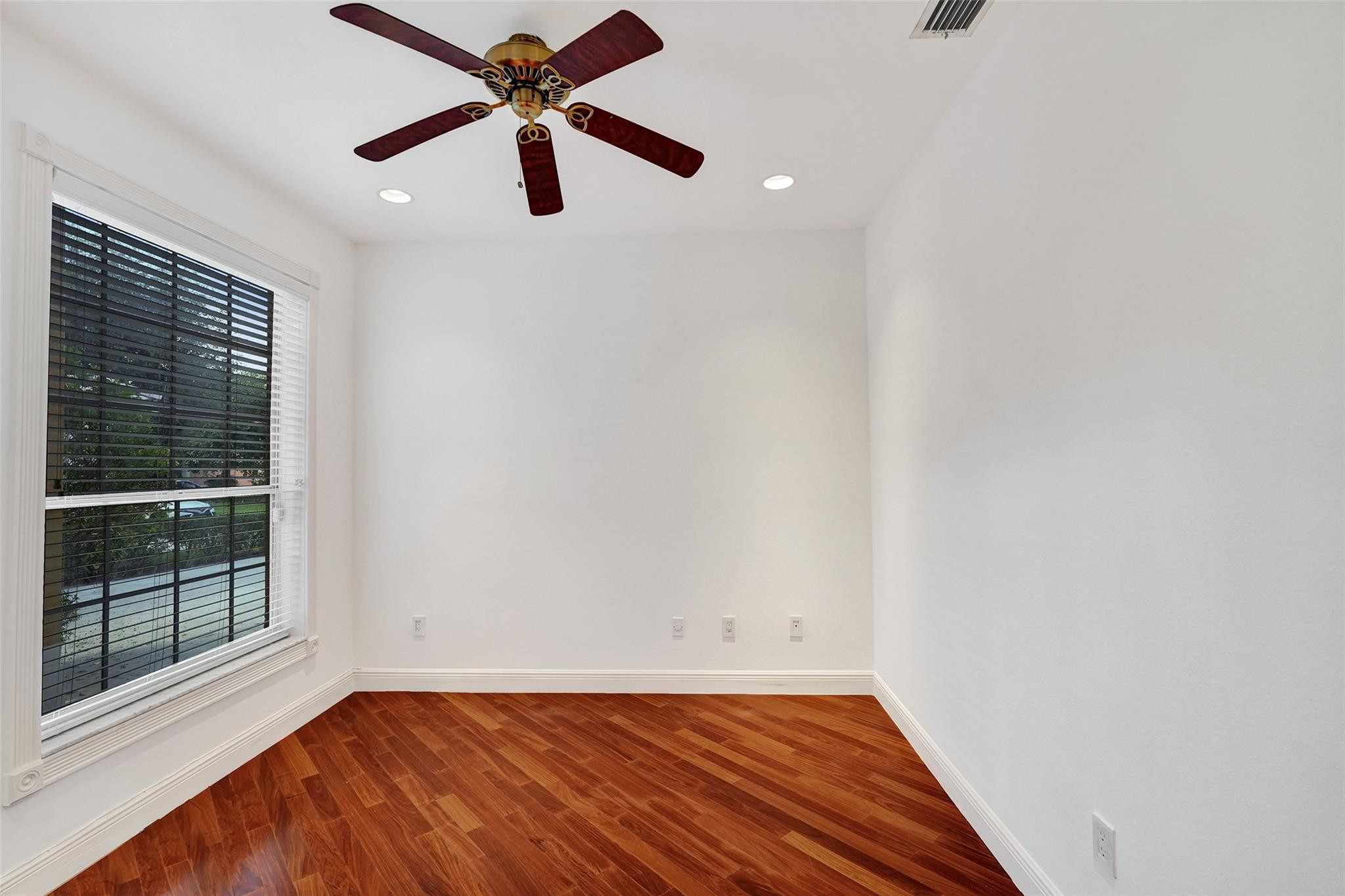 10902 Tamoron Lane Boca Raton, FL 33498 - Photo 23 of 66 a view of empty room with wooden floor and fan