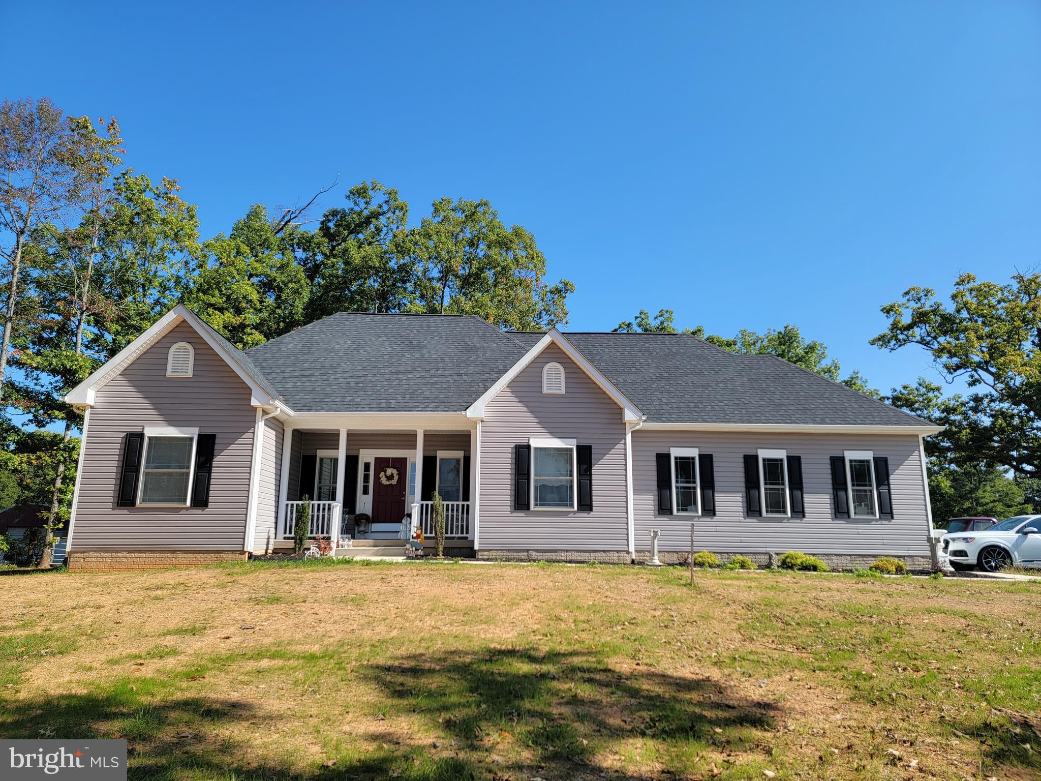 a front view of a house with a yard table and chairs