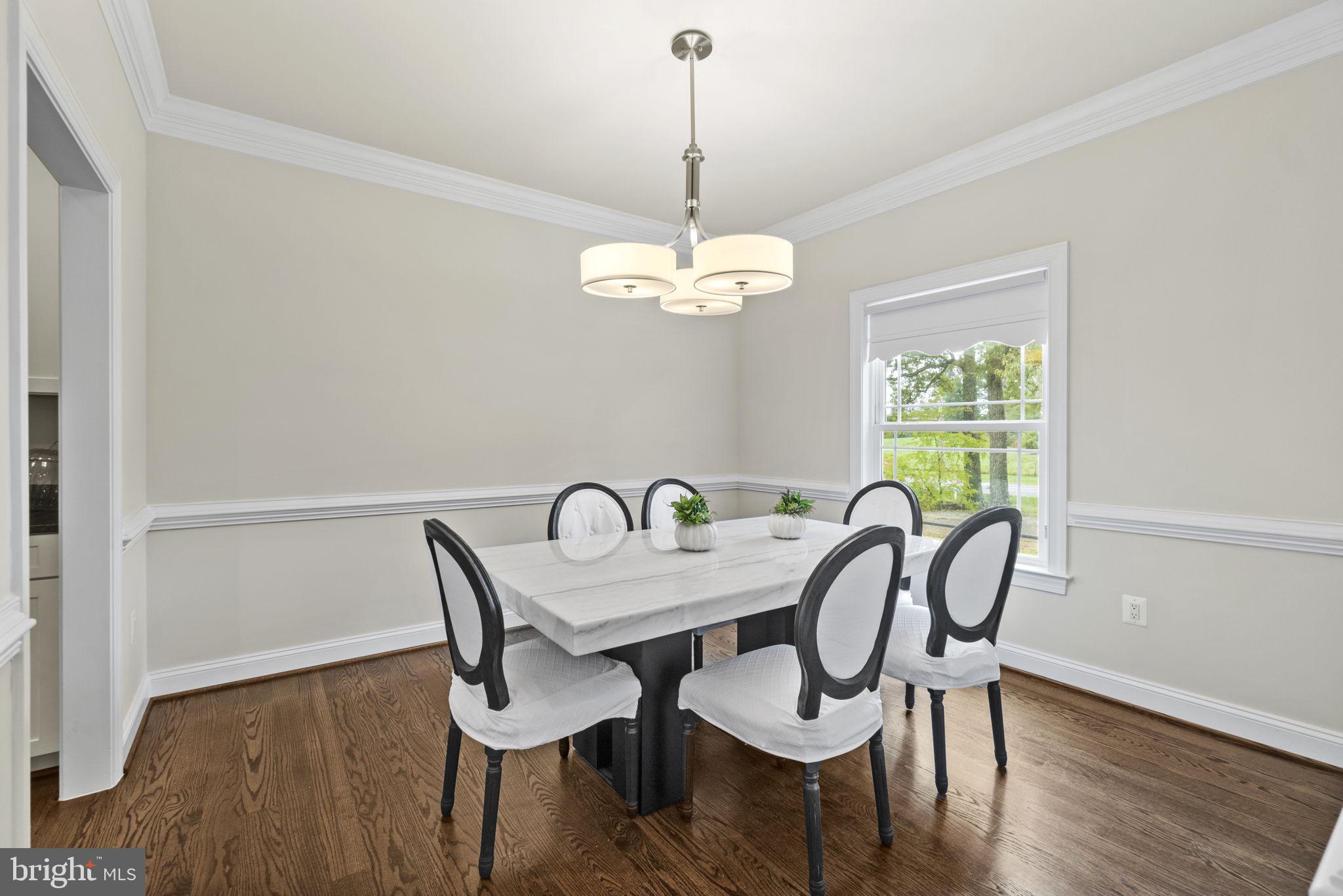 7946 Rogues Road Catlett, VA 20119 - Photo 12 of 50 a dining room with furniture a chandelier and wooden floor