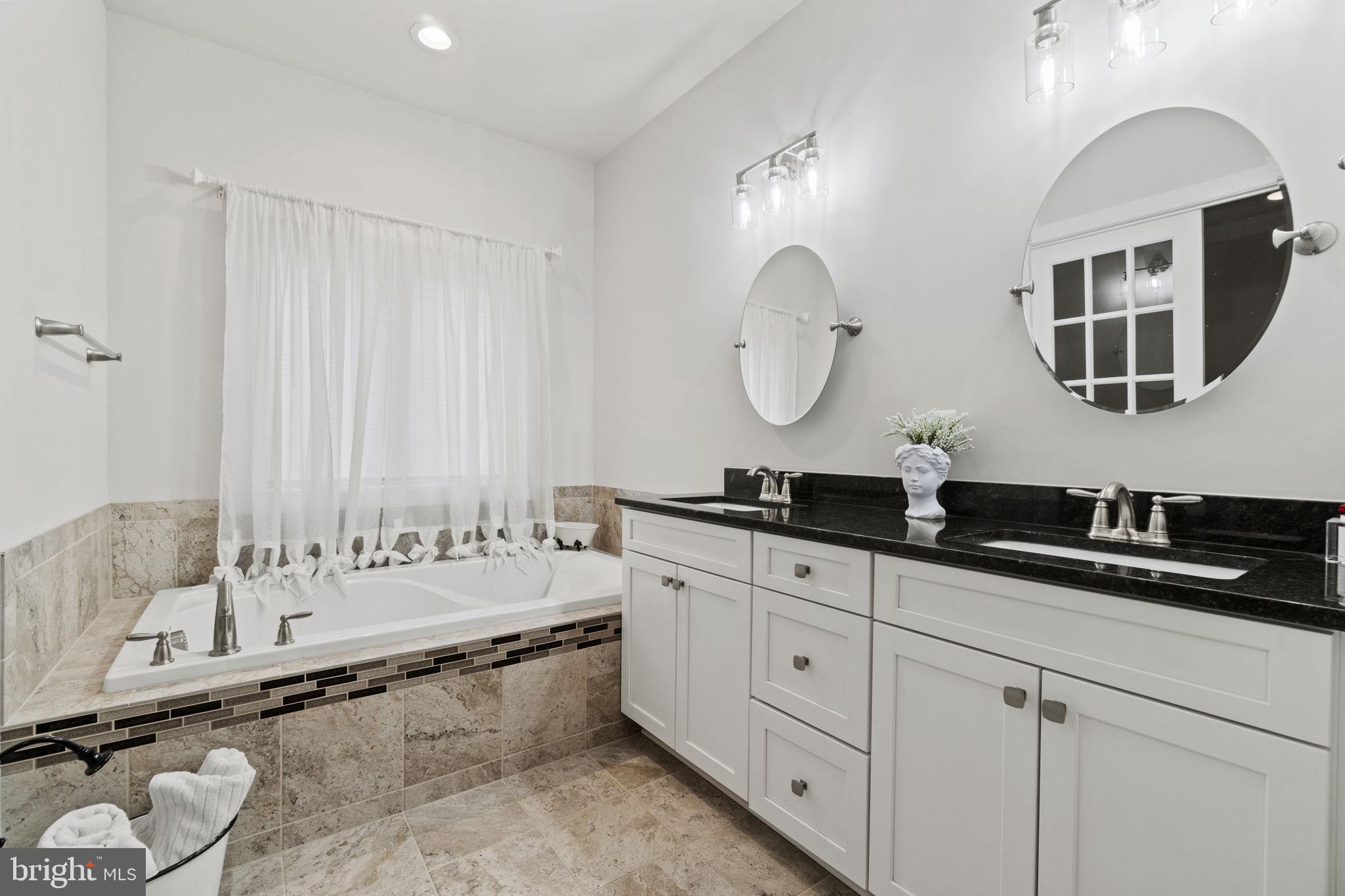 7946 Rogues Road Catlett, VA 20119 - Photo 13 of 50 a bathroom with a double vanity sink and a mirror