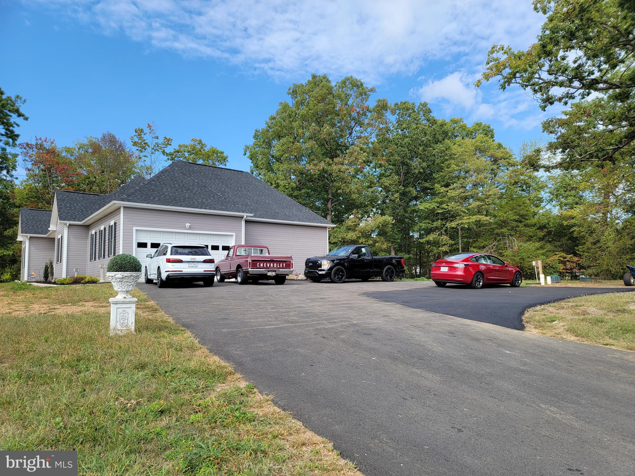 7946 Rogues Road Catlett, VA 20119 - Photo 27 of 50 a front view of a house with a garden and parking