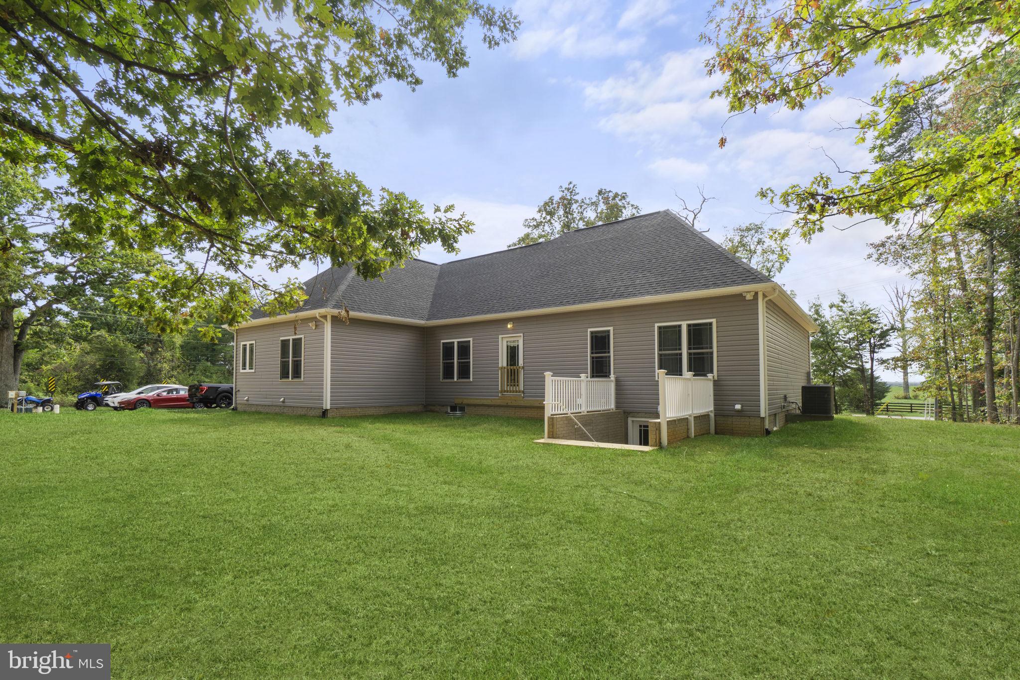 7946 Rogues Road Catlett, VA 20119 - Photo 34 of 50 a front view of a house with a garden