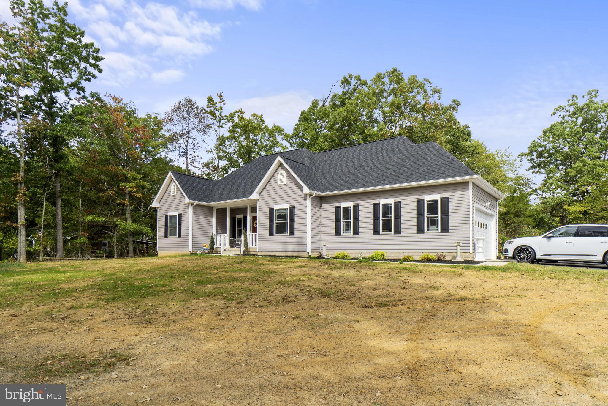 7946 Rogues Road Catlett, VA 20119 - Photo 47 of 50 a front view of a house with a garden