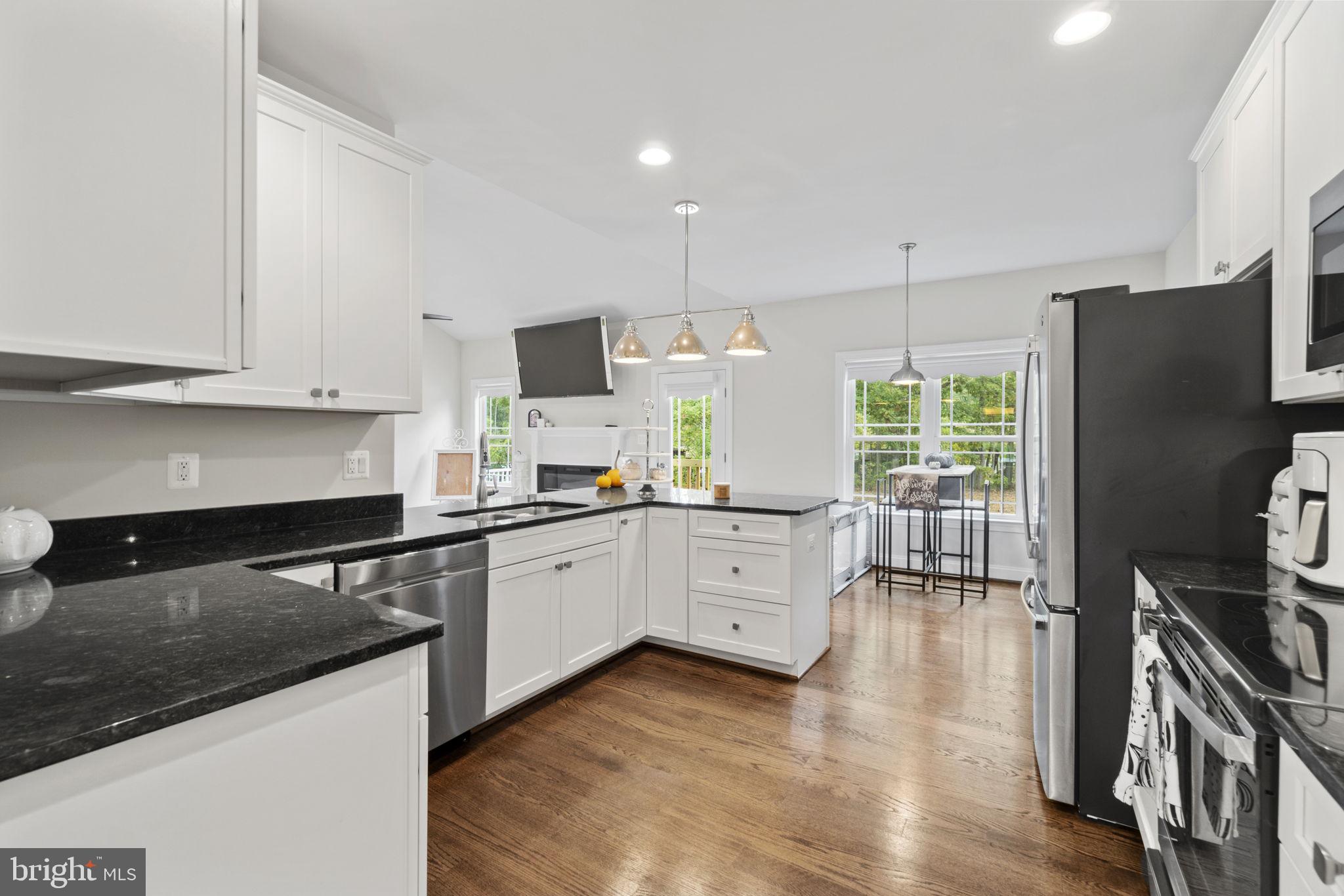 7946 Rogues Road Catlett, VA 20119 - Photo 9 of 50 a kitchen with granite countertop a refrigerator stove and sink