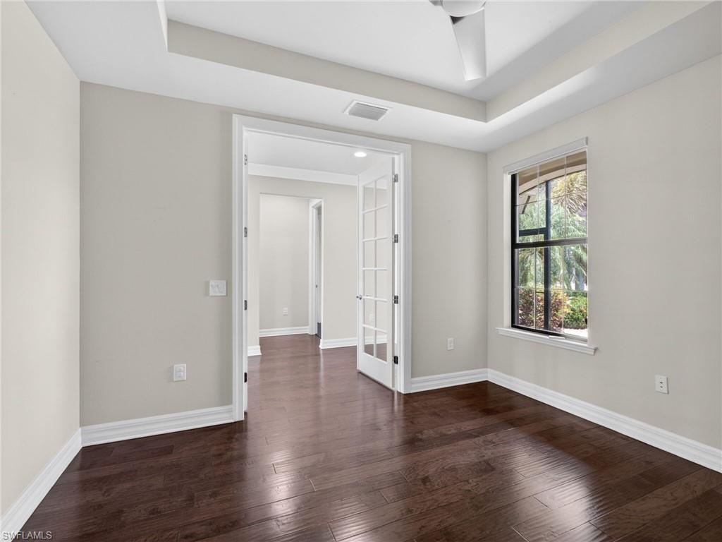 6124 Victory Drive Ave Maria, FL 34142 - Photo 33 of 50 an empty room with wooden floor and windows