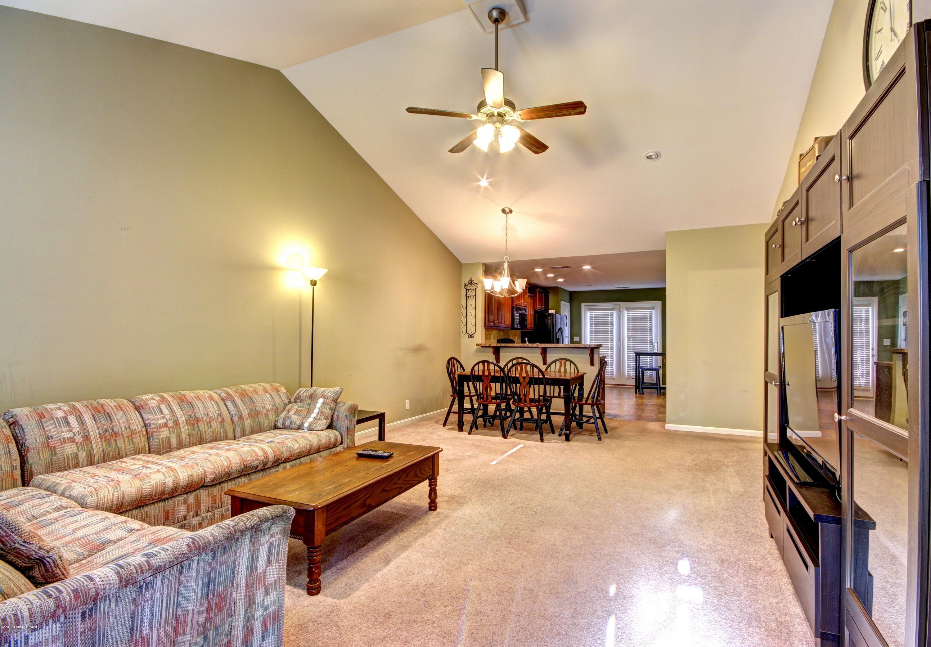 Large vaulted living room opens to the kitchen