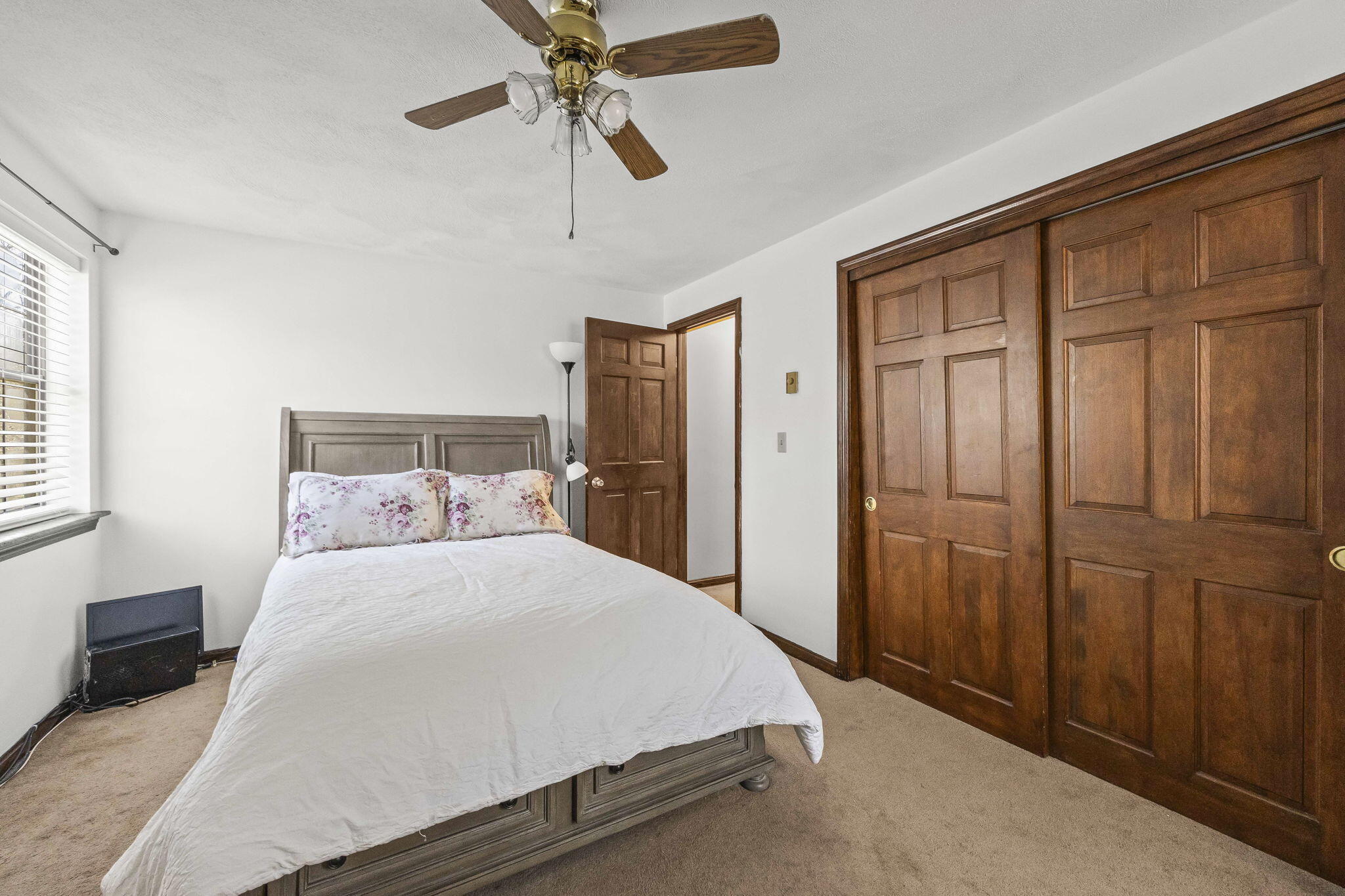 35 Ashumet Road, Unit 8C Mashpee, MA 02649 - Photo 16 of 24 a bedroom with a large bed and a chandelier fan