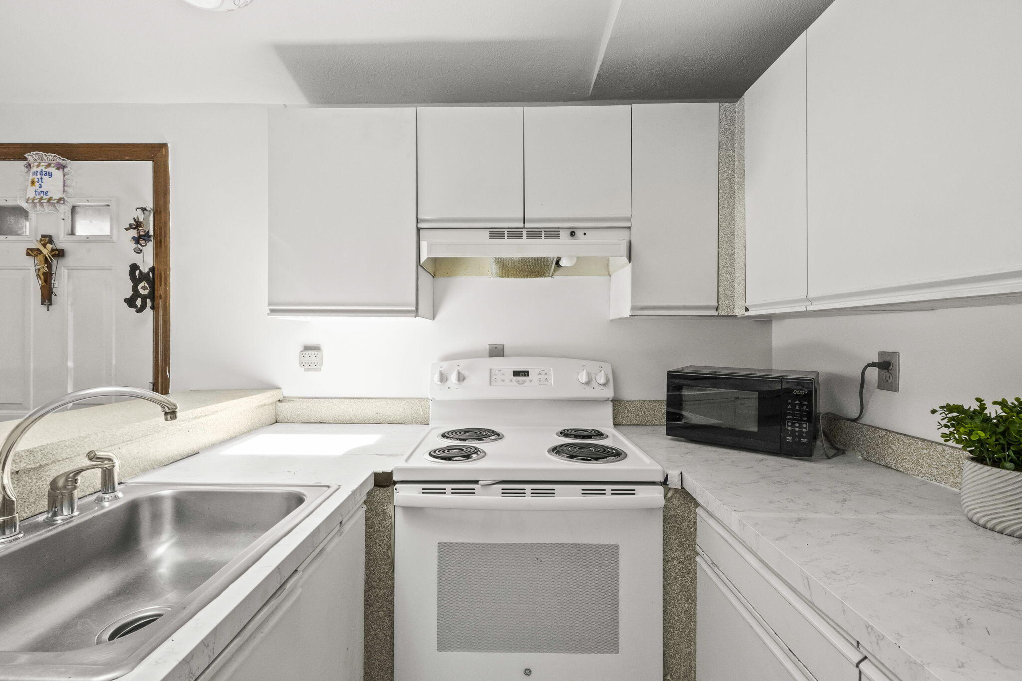 35 Ashumet Road, Unit 8C Mashpee, MA 02649 - Photo 8 of 24 a kitchen with cabinets a sink and white appliances