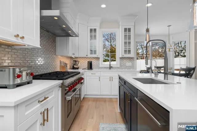 a kitchen with a sink stove top oven and cabinets