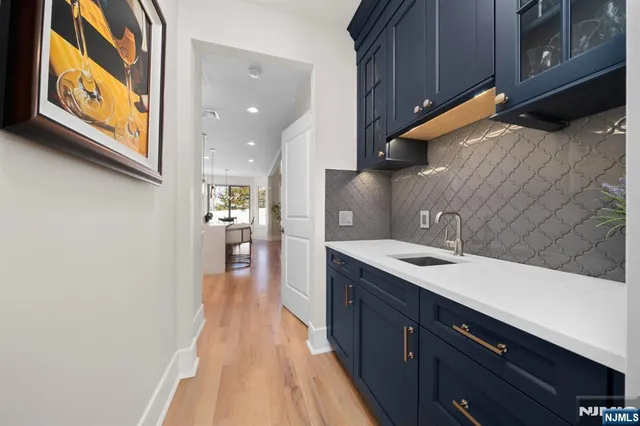 a kitchen with stainless steel appliances granite countertop a sink and wooden cabinets with a granite countertops