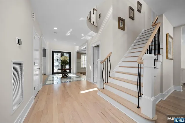 a view of a hallway with wooden floor and staircase