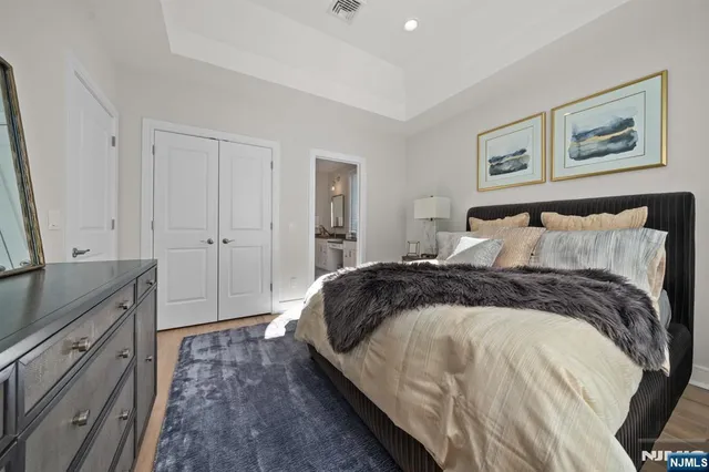 a bedroom with a bed and a painting on the wall