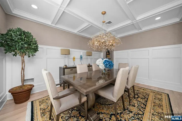 a view of a dining room with furniture and chandelier