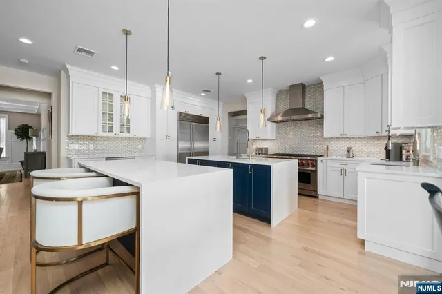 a kitchen with kitchen island granite countertop wooden cabinets and white appliances