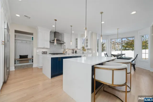 a kitchen with kitchen island granite countertop wooden cabinets and a refrigerator