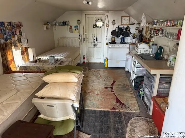 a bed room with a bed a mirror and dresser