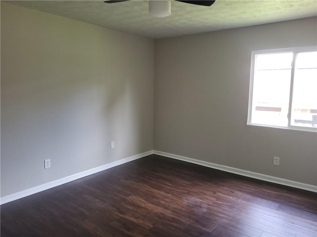 1867 Myrtle Drive Southwest, Unit 26 Atlanta, GA 30311 - Photo 12 of 15 an empty room with wooden floor and windows