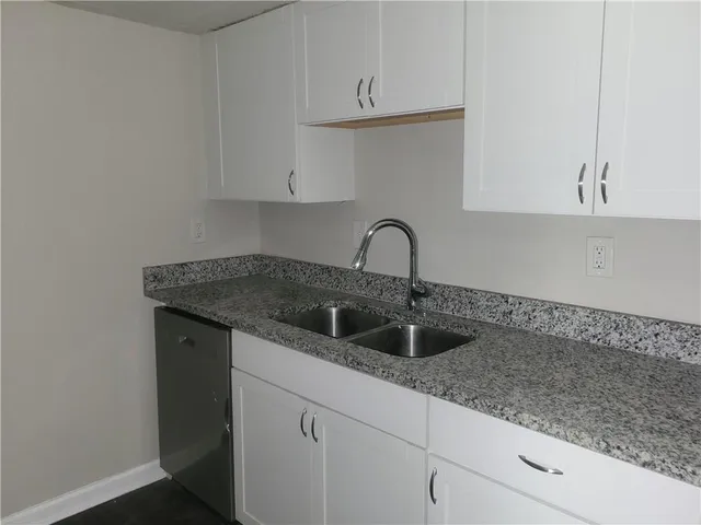 a kitchen with a sink and cabinets