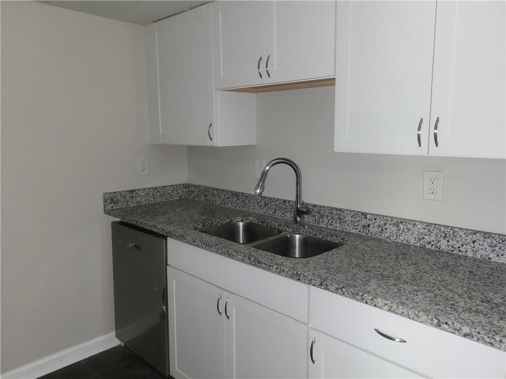 1867 Myrtle Drive Southwest, Unit 26 Atlanta, GA 30311 - Photo 4 of 15 a kitchen with a sink and cabinets