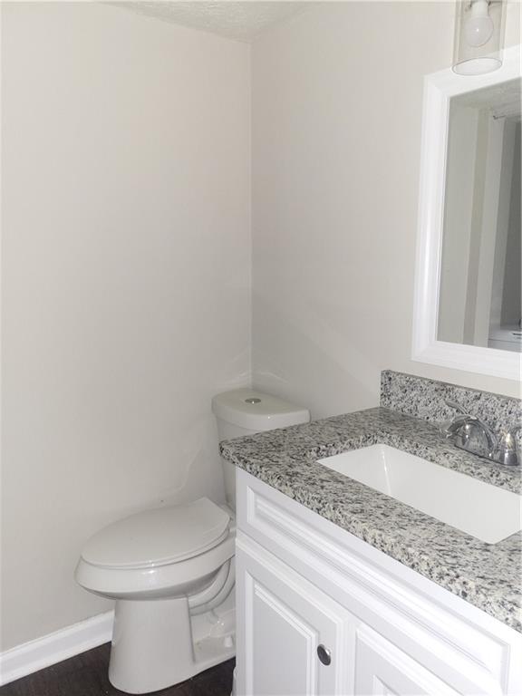 1867 Myrtle Drive Southwest, Unit 26 Atlanta, GA 30311 - Photo 6 of 15 a bathroom with a granite countertop toilet and a sink