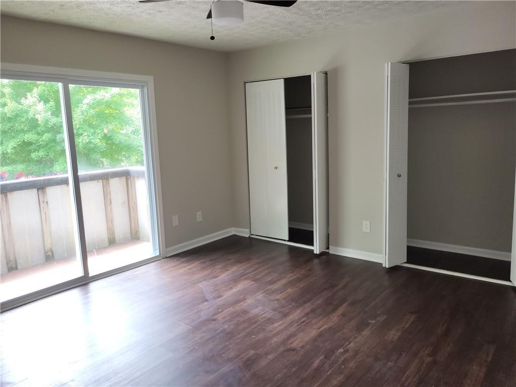 1867 Myrtle Drive Southwest, Unit 26 Atlanta, GA 30311 - Photo 9 of 15 a view of an empty room with wooden floor and a window