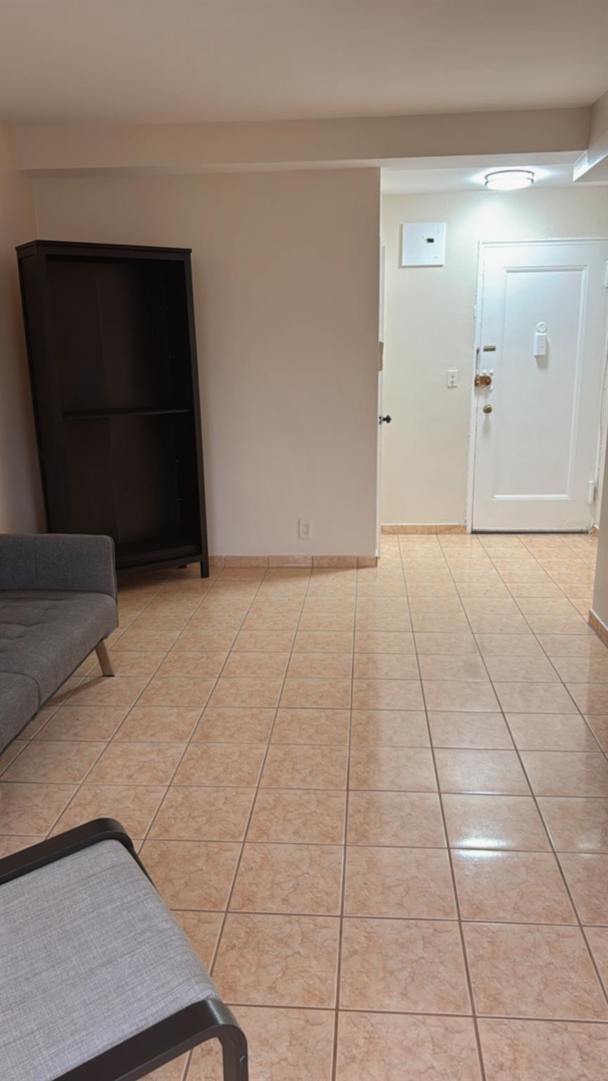 99-40 63rd Road, Unit 9S Queens, NY 11374 - Photo 1 of 1 Living area with light tile patterned floors