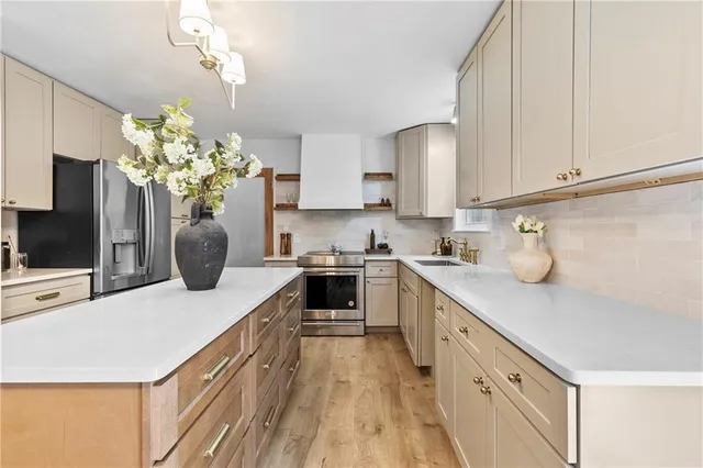 a kitchen with kitchen island granite countertop a sink a counter space and cabinets