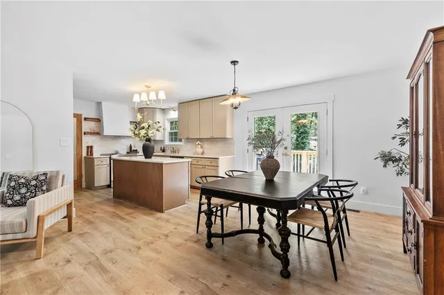a kitchen with a table chairs and a refrigerator