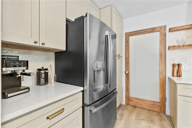 a kitchen with refrigerator and cabinets