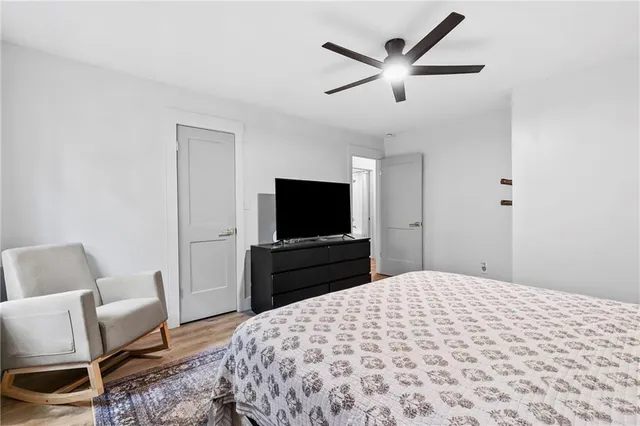 a bedroom with a bed and a flat screen tv