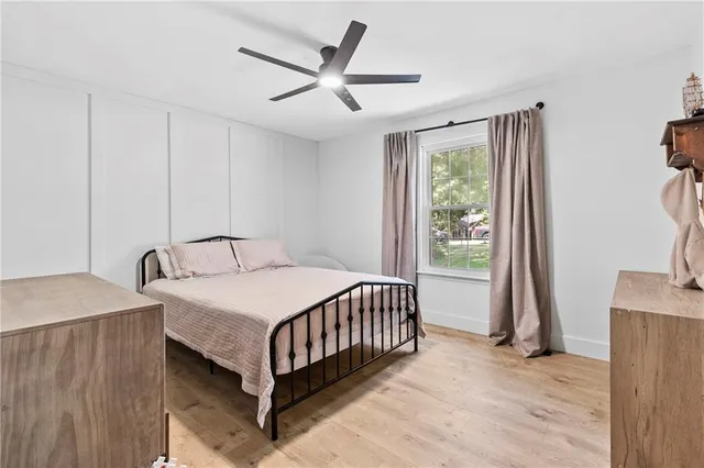 a bedroom with a bed and a large window