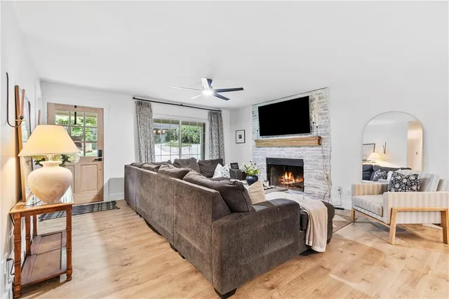 a living room with furniture a fireplace and a flat screen tv