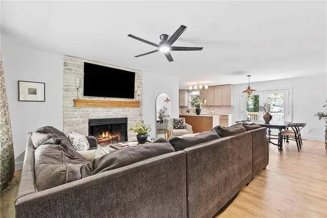 a living room with furniture a fireplace and a flat screen tv