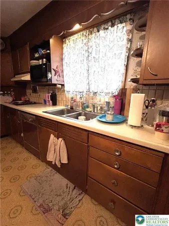 a kitchen with a sink and a stove