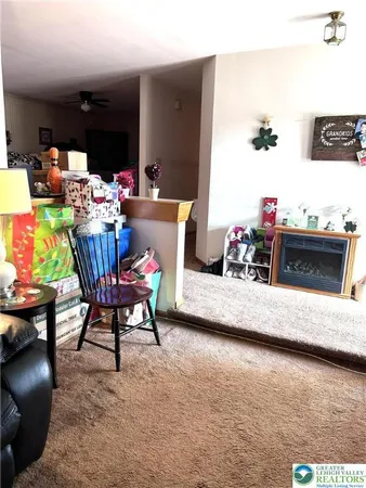 a livingroom with furniture and a stove