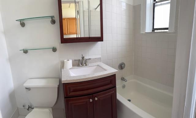 Full bath with vanity, shower / bathtub combination, and decorative backsplash