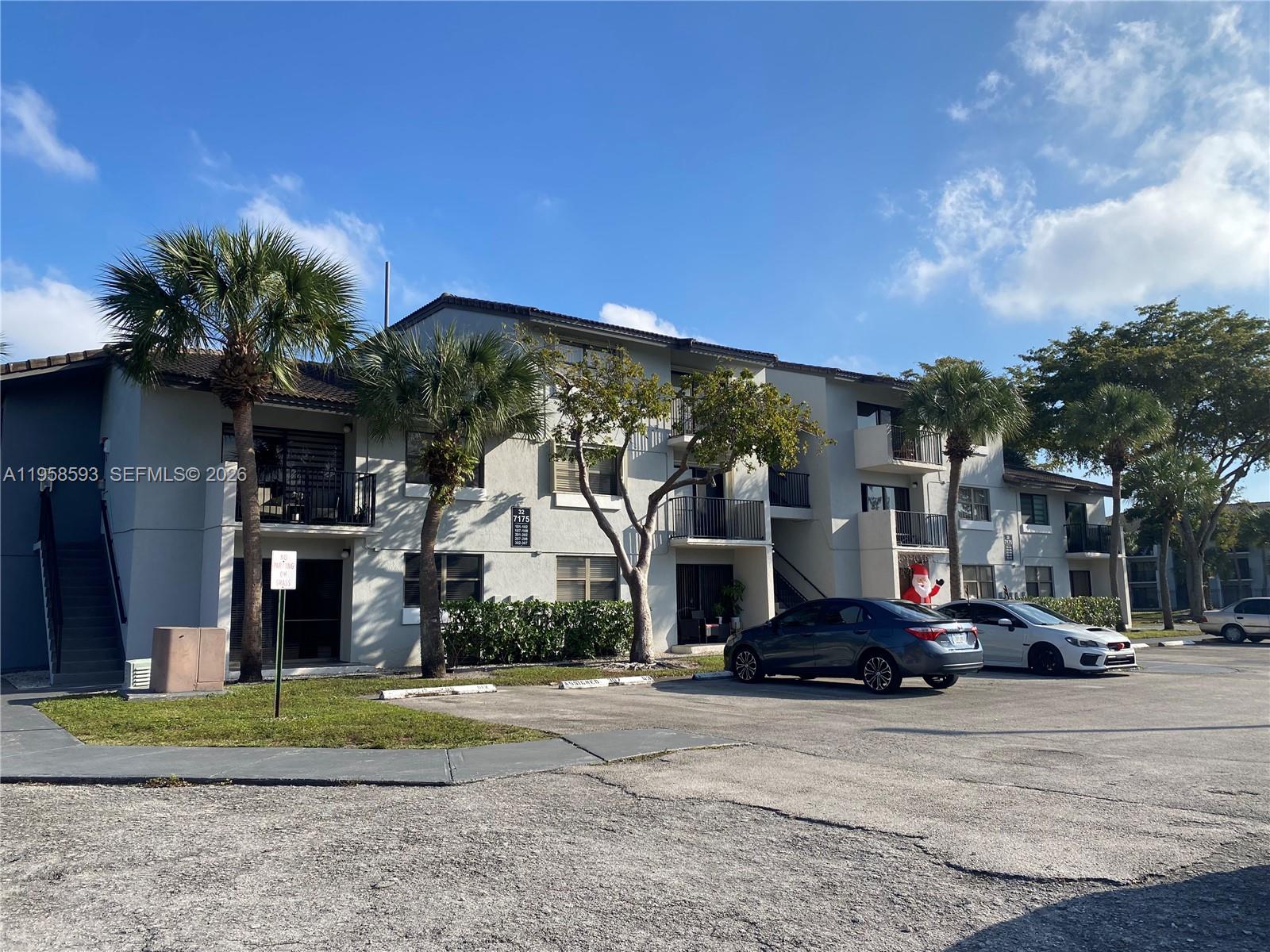7175 Northwest 179th Street, Unit 302 Hialeah, FL 33015 - Photo 1 of 49 a view of a building with a street