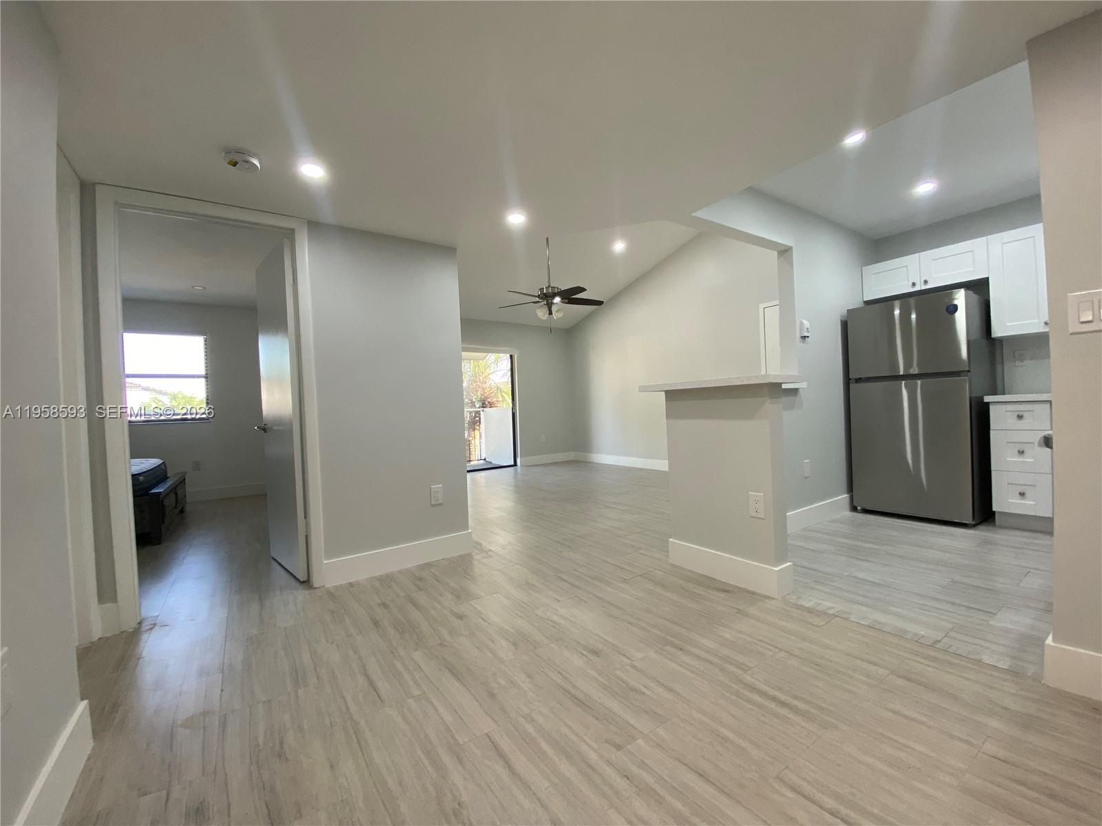 7175 Northwest 179th Street, Unit 302 Hialeah, FL 33015 - Photo 17 of 49 a view of a kitchen with a refrigerator and a stove