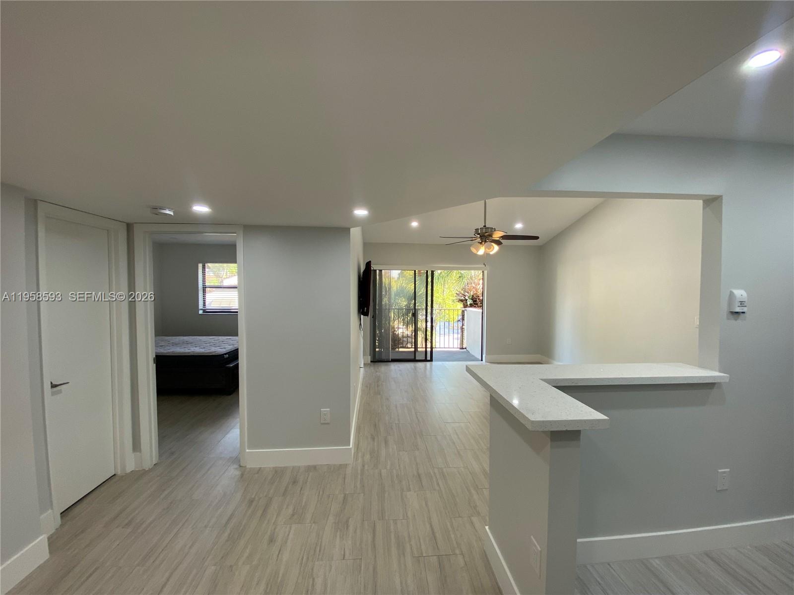 7175 Northwest 179th Street, Unit 302 Hialeah, FL 33015 - Photo 18 of 49 a view of hallway with wooden floor and cabinet