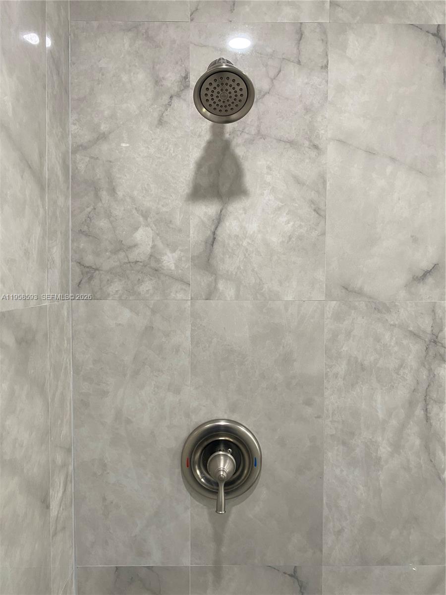 7175 Northwest 179th Street, Unit 302 Hialeah, FL 33015 - Photo 26 of 49 a bathroom with a shower