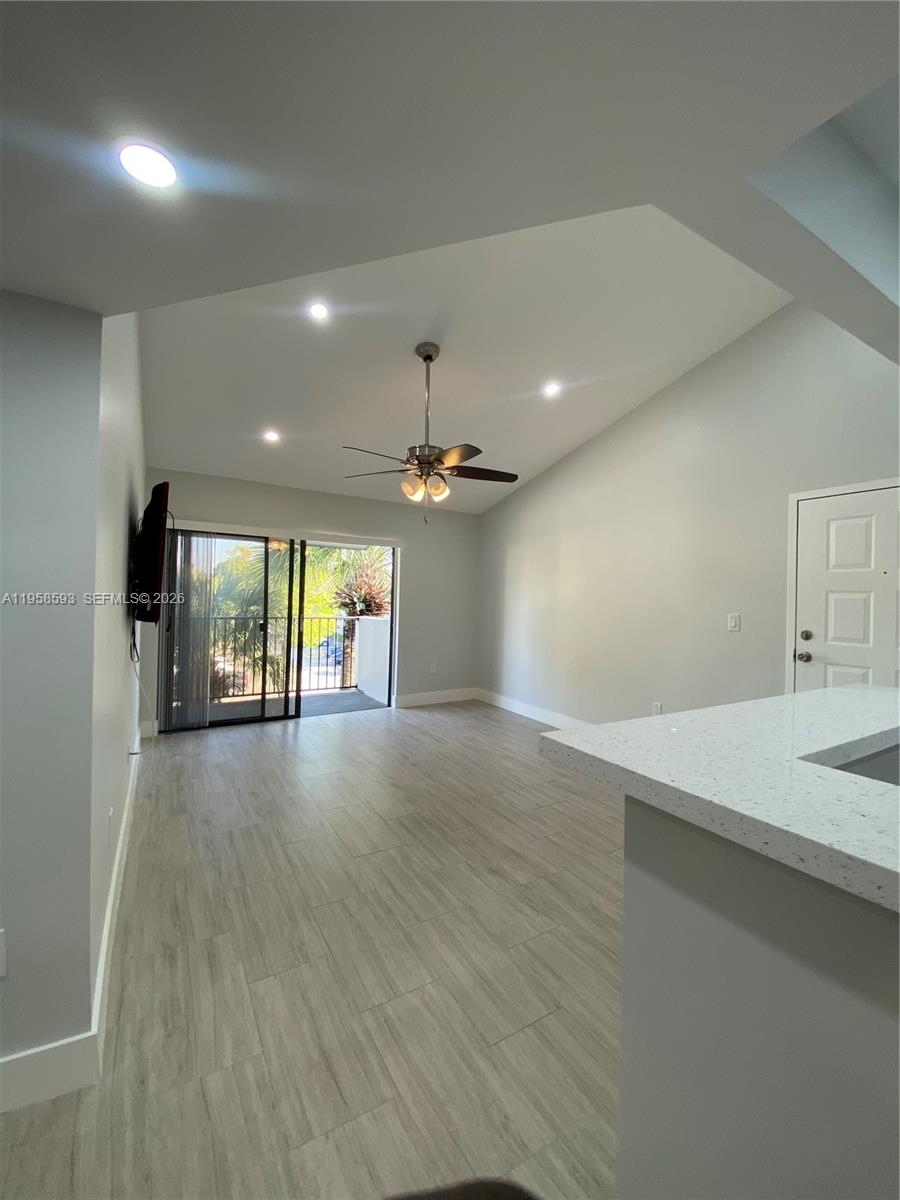 7175 Northwest 179th Street, Unit 302 Hialeah, FL 33015 - Photo 30 of 49 an empty room with windows and chandelier