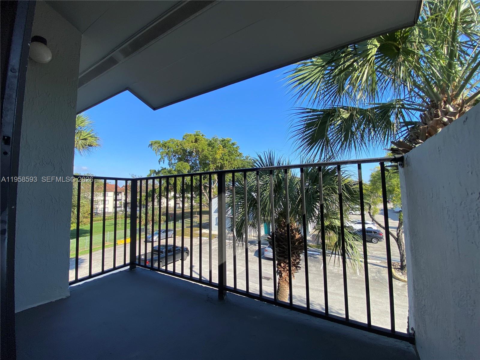 7175 Northwest 179th Street, Unit 302 Hialeah, FL 33015 - Photo 35 of 49 a view of a swimming pool with a garden