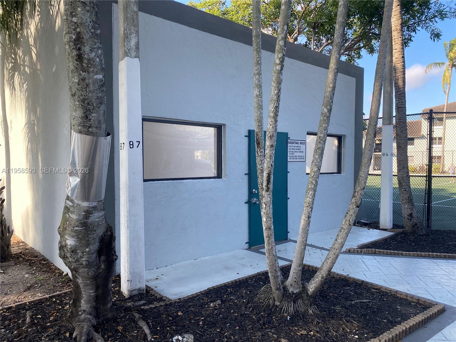 7175 Northwest 179th Street, Unit 302 Hialeah, FL 33015 - Photo 48 of 49 a view of a house with a backyard