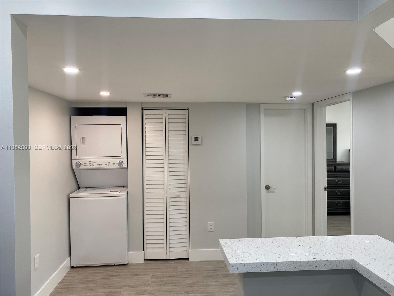 7175 Northwest 179th Street, Unit 302 Hialeah, FL 33015 - Photo 10 of 49 a view of a hallway with washer and dryer