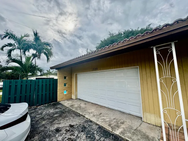 a couple of potted plants in front of door