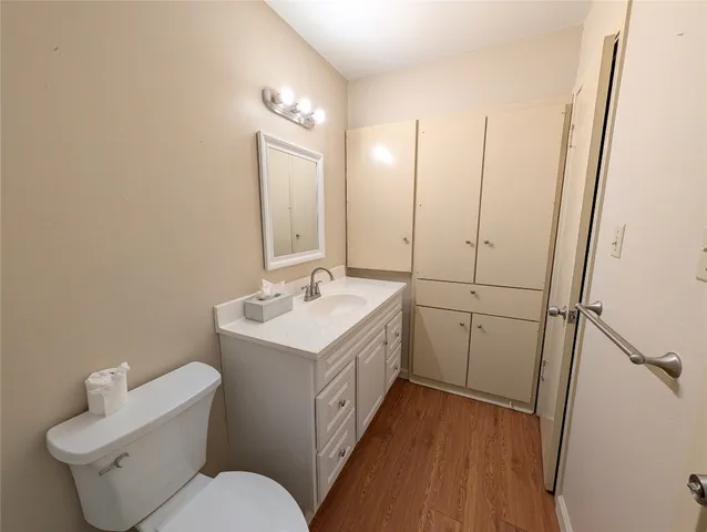 a bathroom with a sink and mirror with toilet