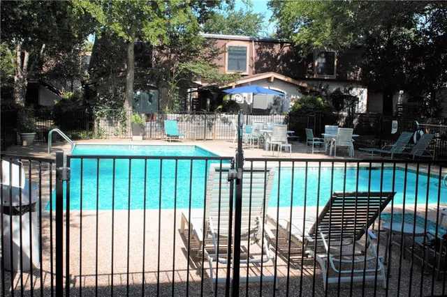 a view of a house with backyard and trees